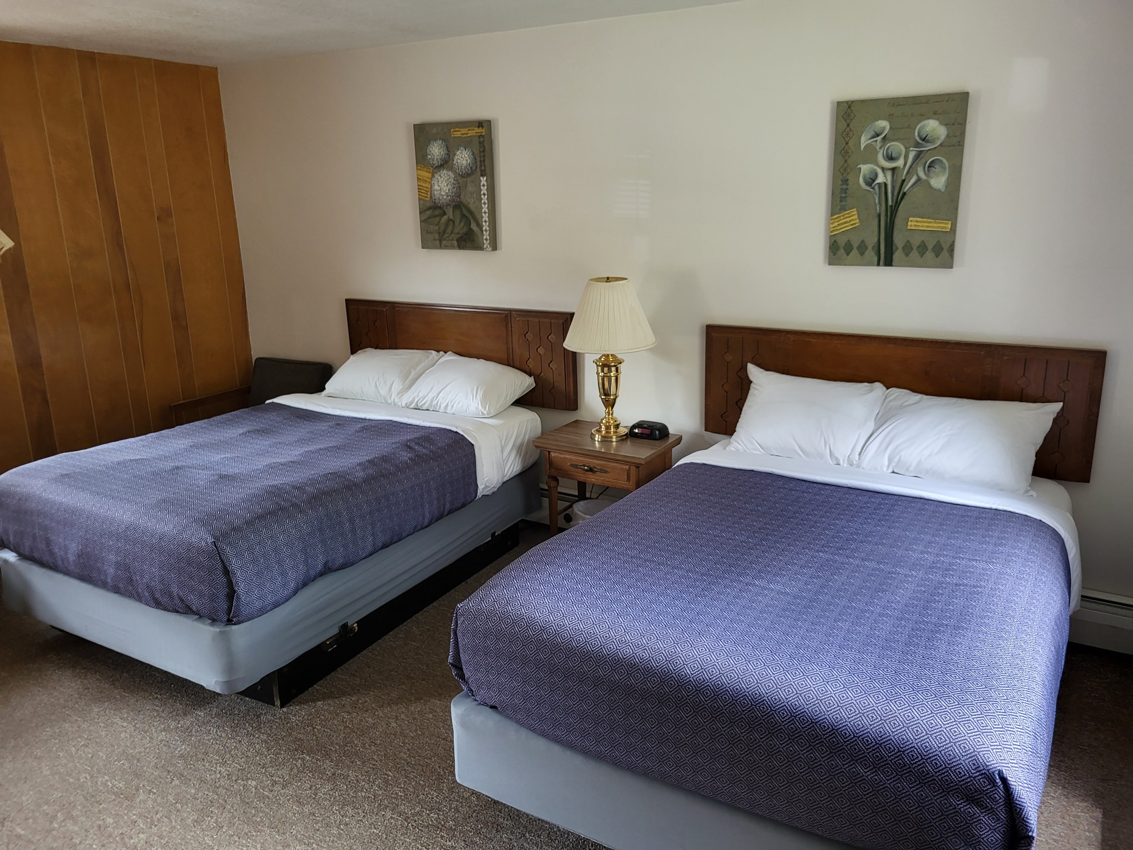 Pine Wood Motel Room 1 — queen bed with wood paneling