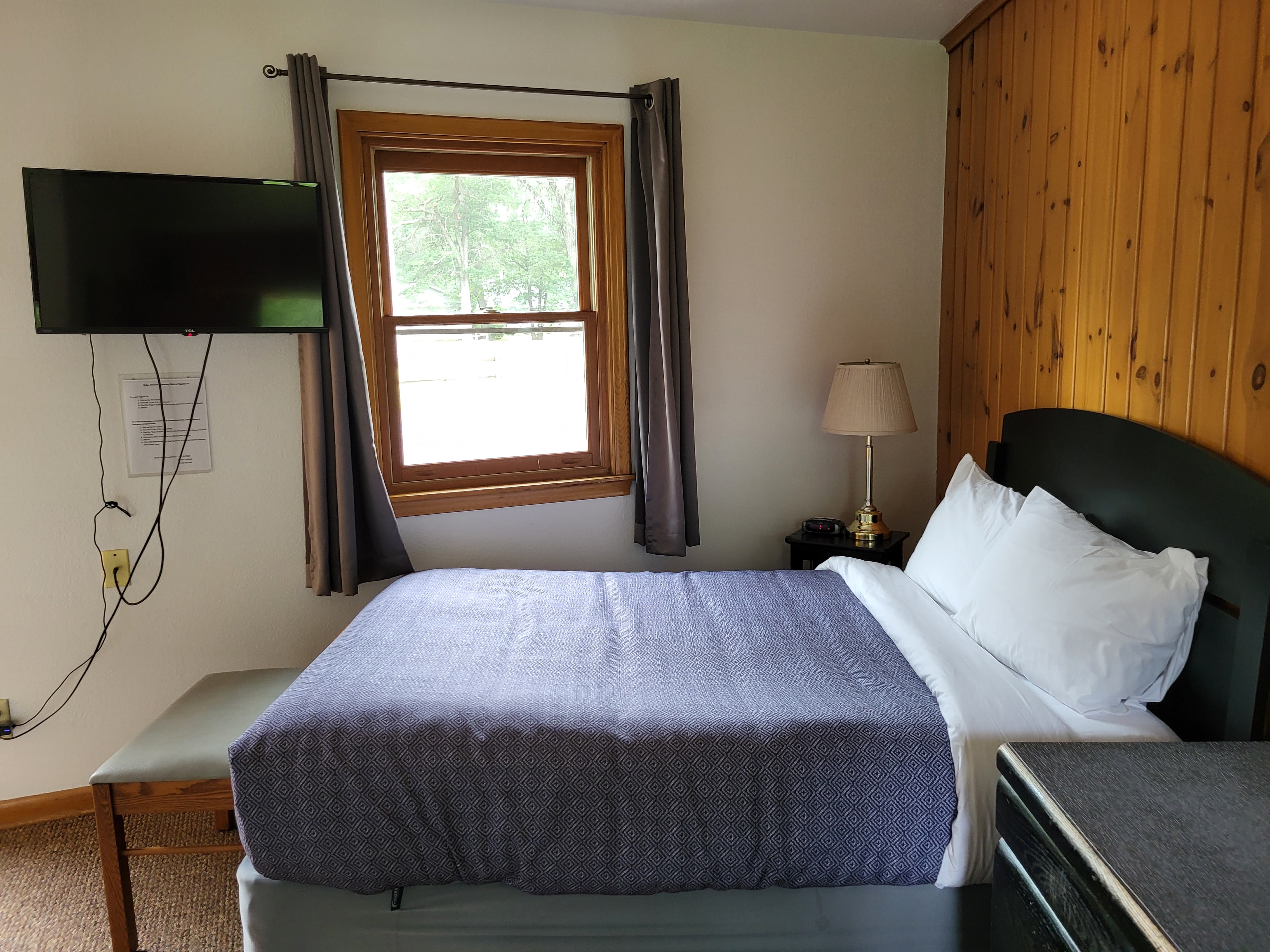 Pine Wood Motel Room 11 — king bed with dark wood furniture