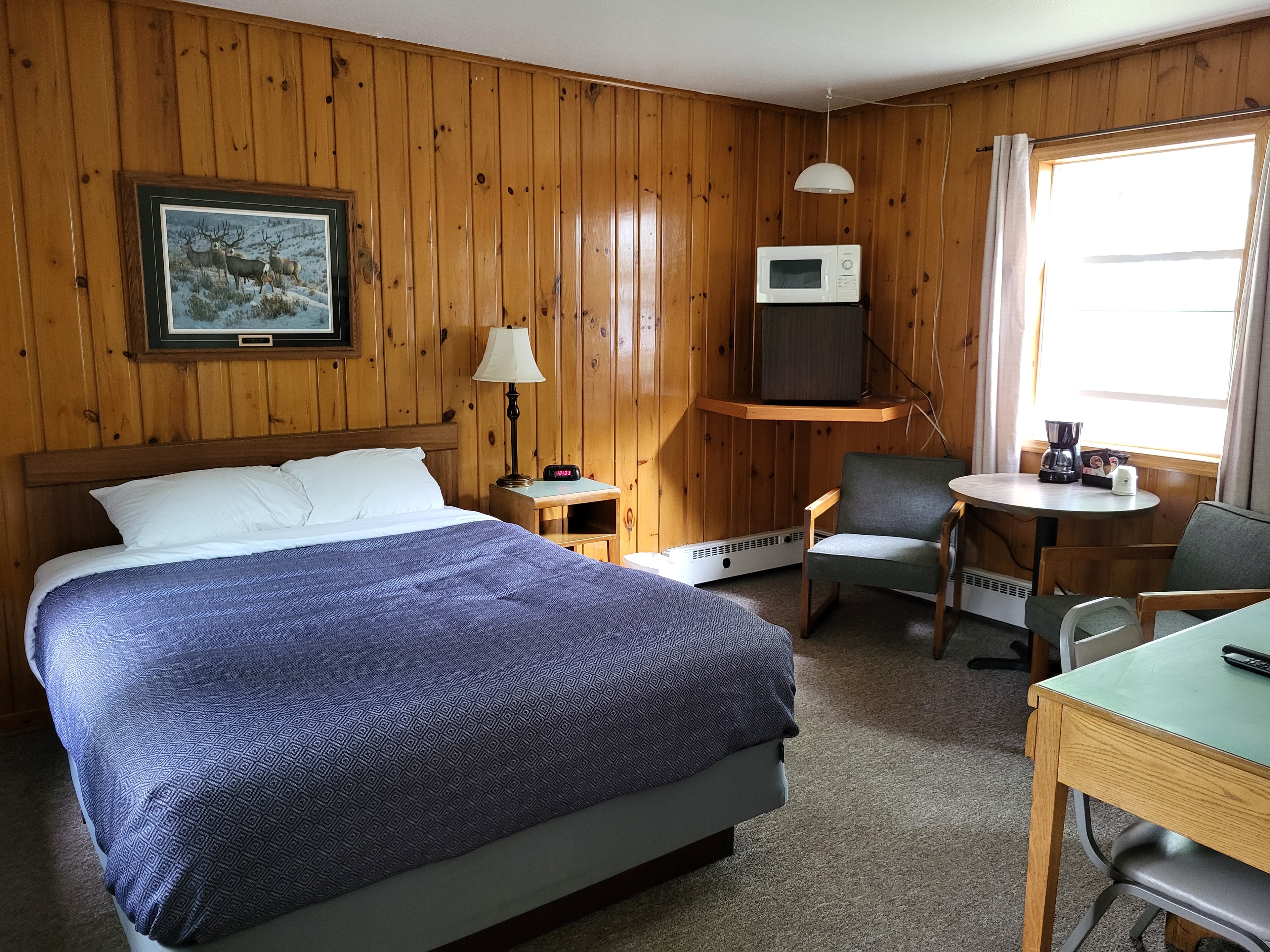 Pine Wood Motel Room 7 — double bed with teal accents
